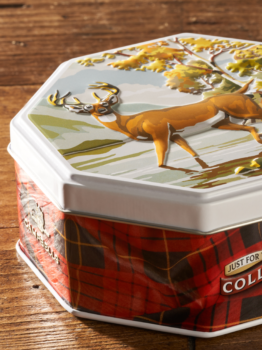 Metal biscuit tin with a tartan embossed design.