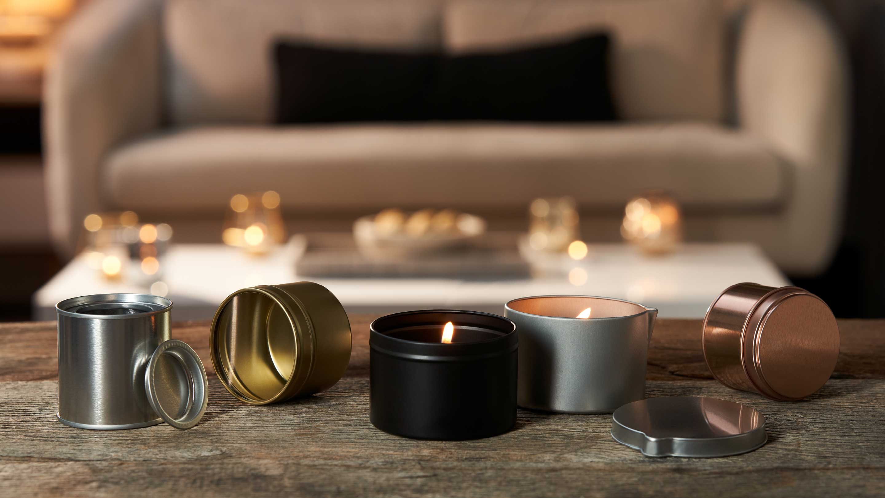 Round metal packaging boxes and metal candle tins in a home.