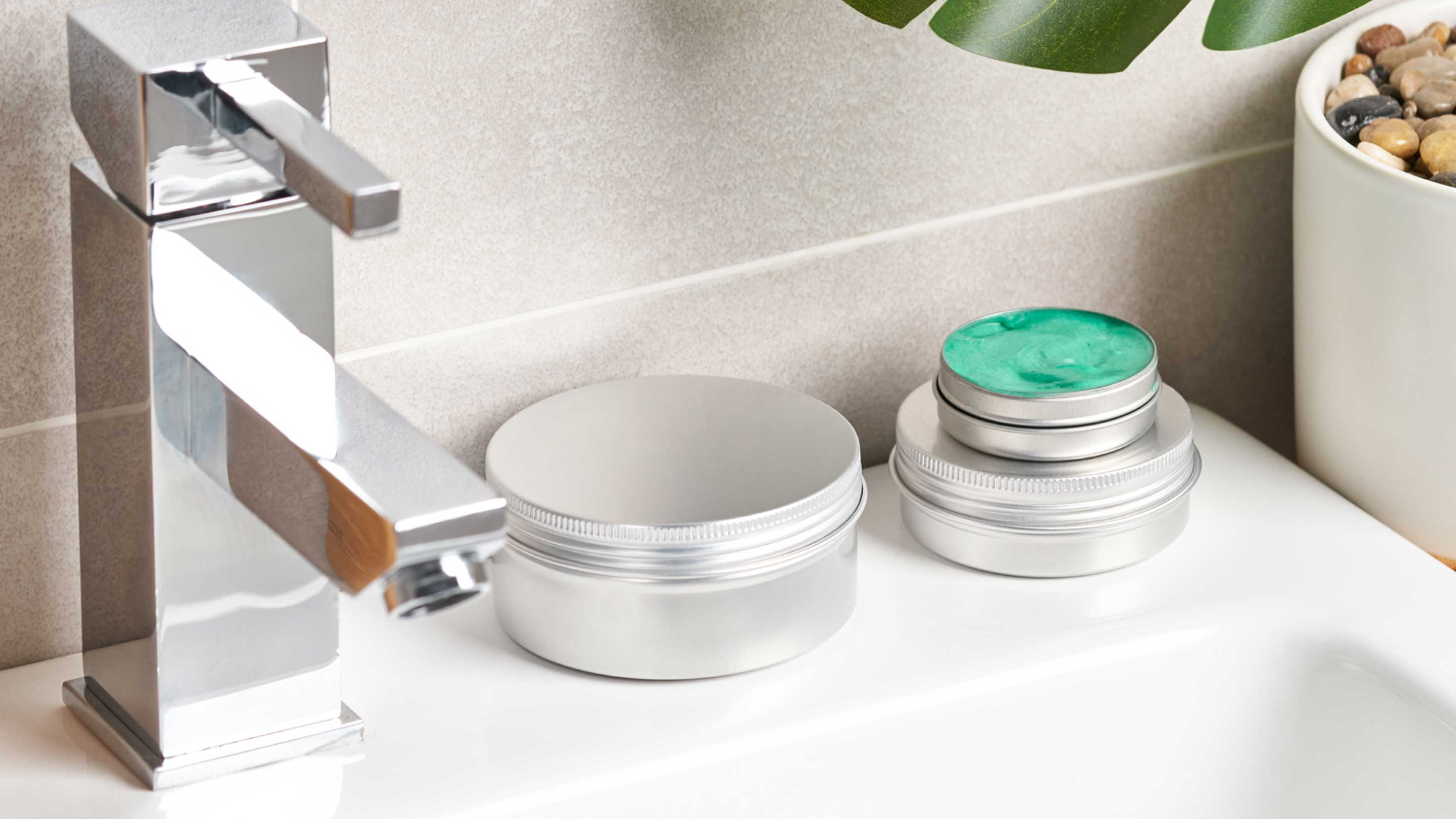 Aluminium box packaging with cosmetics inside in a bathroom.
