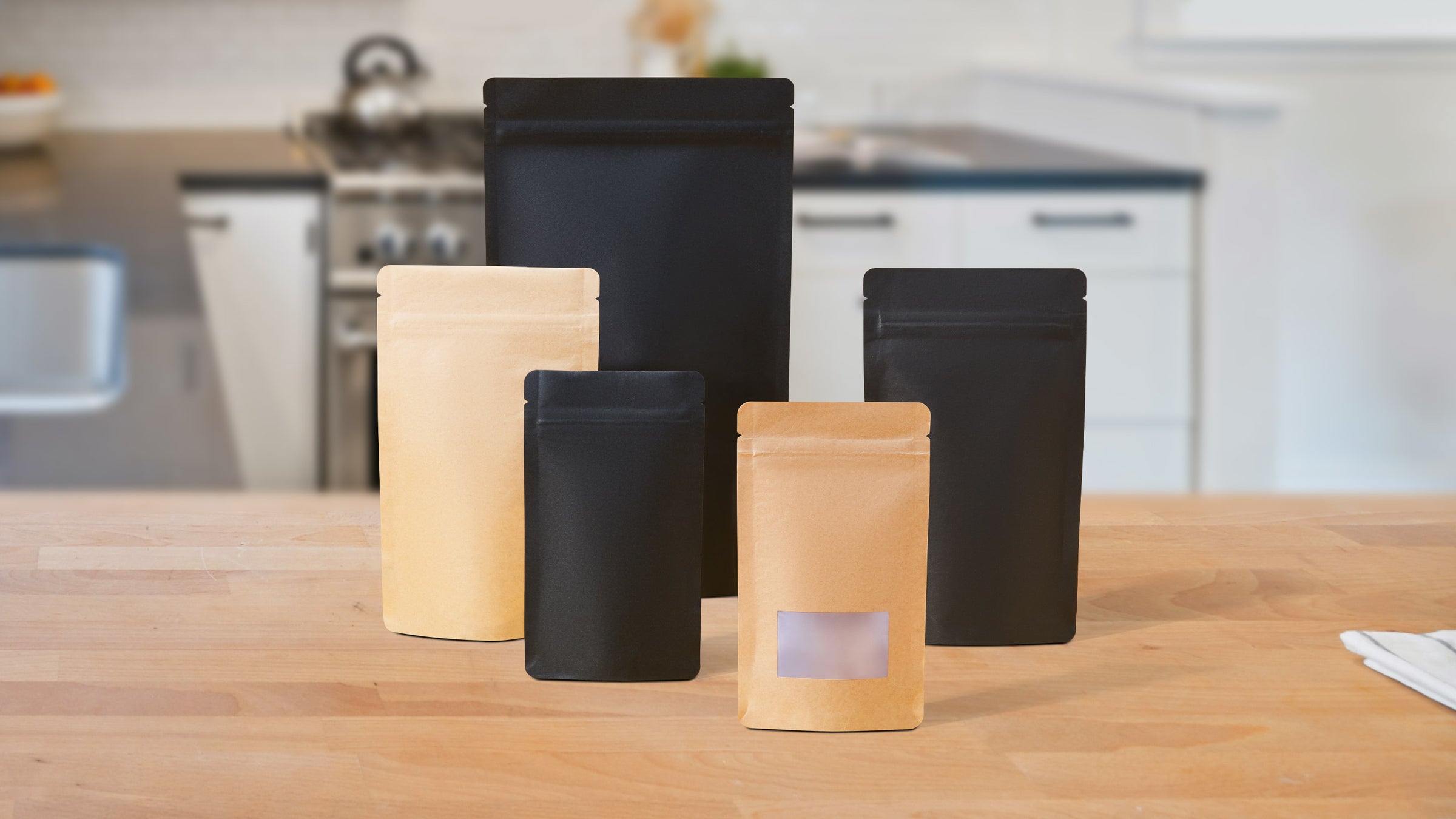 Stand up packaging pouches in black and brown in a kitchen.